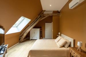 an attic bedroom with a bed and a window at Domaine des grands chênes in Préveranges +28 photos