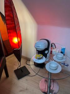a coffee maker on a glass table next to a surfboard at ANCiENT CiTY WALL in Nuremberg