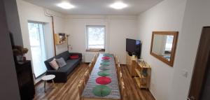 a living room with a couch and a table at Penzion MJT - Harrachov in Harrachov