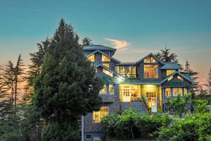 a large house with a tree at Alaya Stays Hill Top Farmstead Heritage 3 BHK English-Style Villa With Balcony, Gazebo in Nāldera