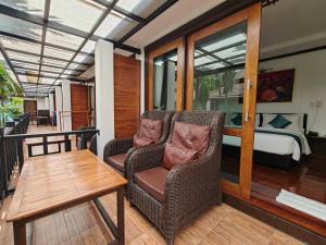 a balcony with a chair and a table and a bed at Cabana Lipe Beach Resort in Ko Lipe