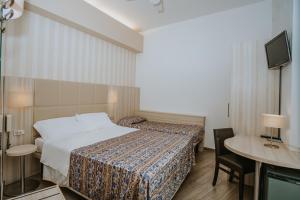 Postel nebo postele na pokoji v ubytování Hotel Gabriella