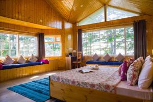 a bedroom with a bed in a room with windows at Alaya Stays Hill Top Farmstead Heritage 3 BHK English-Style Villa With Balcony, Gazebo in Nāldera +74 photos