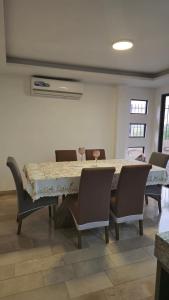 a dining room with a table and chairs at Casa Moderna con Piscina y Espacios al Aire Libre en Ciudad Celeste, Samborondón in Barranco +34 photos