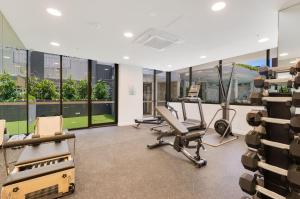 a gym with chairs and treadmills in a building at Sol Apartments Unit 604 in Gold Coast