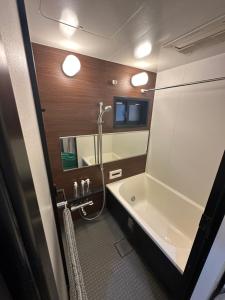 Un baño con ducha, bañera y lavabo. en APATEL Shinsaibashi, en Osaka 10 fotos más