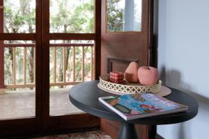 a table with a bowl of fruit and a magazine at Kings and Queens Paterson in Paterson +28 photos