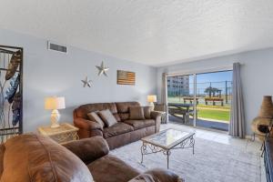 a living room with a couch and a table at Plantation Palms 6103 in Gulf Highlands +35 photos