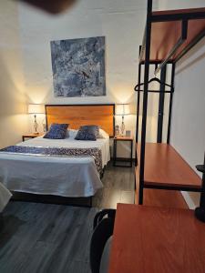 a hotel room with a bed and a ladder at BKL Hotel Oaxaca in Oaxaca City
