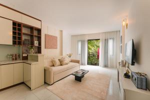 a living room with a couch and a tv at Classic house 3MasterBR HoanKiem Lake by SSens Homes in Hanoi