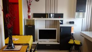 a living room with a tv and a table with a table sidx sidx at Apartment Your second home in Subotica