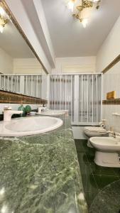 a large bathroom with three sinks and two toilets at Casa Vacanza Stella in Torre Forte