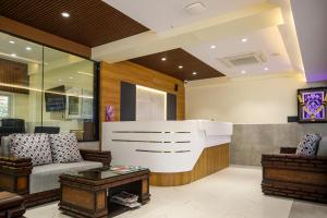 a living room with a couch and a table at Hotel Lemon Park in Visakhapatnam