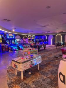 a room with many arcade games and a table at Grand Sapphire Casino 1 bdr 002 in Iskele