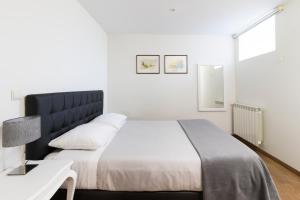 a bedroom with a large bed and a table at Casa da Pousada in Barcelos +48 photos