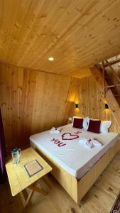 een slaapkamer met een bed in een houten kamer bij Alpine Lodge And Stays in Shangarh
