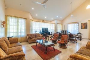 a large living room with couches and a table at Boutique Villa w Bonfire & BBQ, Mussoorie Foothills in Dehradun
