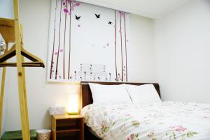 a bedroom with a bed and a window with butterflies at Comfortable as your home - JS1 in Seoul
