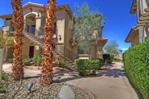a house with palm trees in front of it at La Quinta Vacations Rental in La Quinta