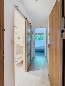 a bathroom with a toilet and a glass door at Studio du château in Vaux-le-Pénil