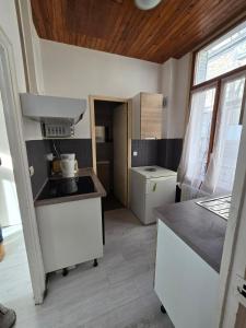a kitchen with a sink and a counter top at Appartement en RDC, lumineux et spacieux vue sur la montagne in La Bourboule