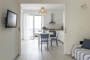 a kitchen and living room with a table and chairs at Sunshine Costa dei Trabocchi - YourPlace Abruzzo in Fossacesia