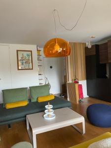 a living room with a couch and a table at Cosy et Arty in Paris