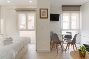 a bedroom with a bed and a table and chairs at Cala Sol - few steps from the beach in La Cala de Mijas