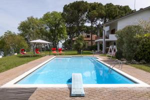a swimming pool in front of a house at Villa Bonaccia - YourPlace Abruzzo in Ortona