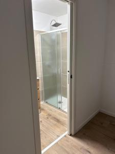 a bathroom with a glass shower with a mirror at Casa Mia in Alife +5 photos