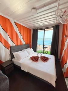 a bedroom with a bed with a view of the ocean at Perhentian Nemo Chalet in Perhentian Island +42 photos