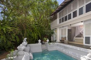 a swimming pool in the backyard of a house at Ravana Garden in Ambalantota