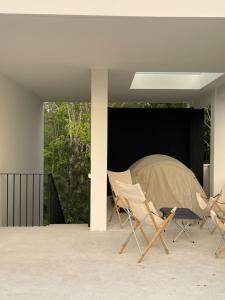 a group of chairs and a tent on a patio at Tree O'clock Pool Villa - Phuket in Thalang
