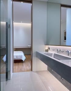 a bathroom with a sink and a mirror at Tree O'clock Pool Villa - Phuket in Thalang