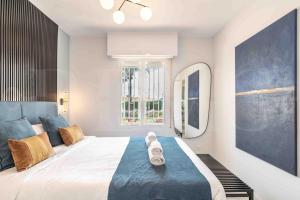 a bedroom with a large bed and a large window at Sunny apartment with balcony & swimming pool by REMS in Sitio de Calahonda +31 photos