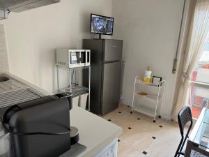 a kitchen with a refrigerator and a tv on top at Riva dei fiori in Viareggio