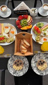 a table topped with plates of food and pastries at Villa White in Ksamil