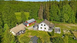 an aerial view of a house in the middle of a field at 1850 Old Farmhouse Retreat with jacuzzi and sauna in Eidsvoll