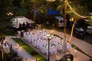 an overhead view of a wedding reception with white tables and chairs at Montem Villa - Venuestay in Lương Sơn +61 photos