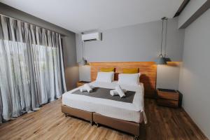 a bedroom with a large bed and a large window at Relax Villa in Marmari