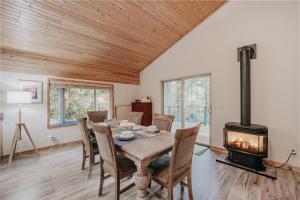 a dining room with a table and a wood stove at Glacier Springs Cabin 2bedrooms 60 The Family Time Cabin in Deming