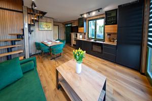 a living room with a table and a kitchen at OSTOJA Ciernie in Ciernie +24 photos