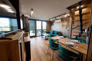 a living room with a table and chairs and a couch at OSTOJA Ciernie in Ciernie