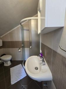 a bathroom with a sink and a toilet at Jovanovic Apartment in Tivat +24 photos