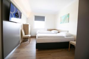 Postel nebo postele na pokoji v ubytování Das Reinisch Just Rooms