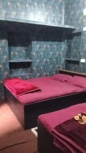 a bedroom with two beds with red sheets at Sri Kashi Kaal Bhairav Guest House in Varanasi