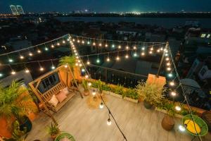 a balcony with lights and plants on a building at K6 Homestay in Hanoi