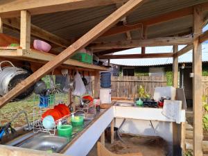 an outdoor kitchen with a sink and aesteadestead at Ciwidey Jungle Camp & Cabin in Gambung