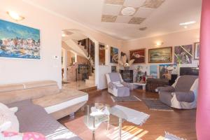 a living room with a couch and a table at Luxury Villa Emily with Private Infinity Pool Breathtaking Adriatic Views in Opric