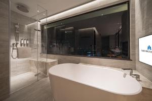 a bath tub in a bathroom with a window at Hotel Nikko Kaohsiung in Kaohsiung +51 photos
